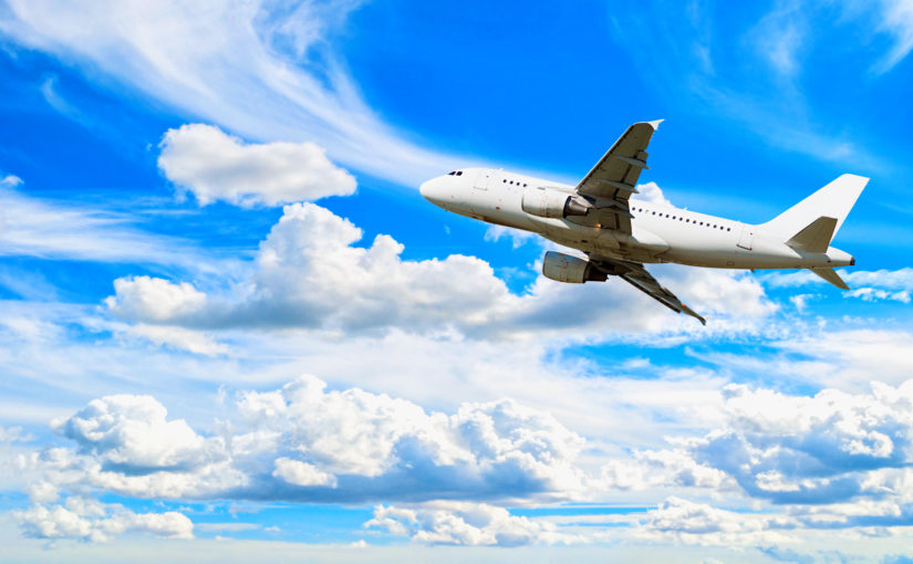 An airplane in the clouds, creating carbon emissions