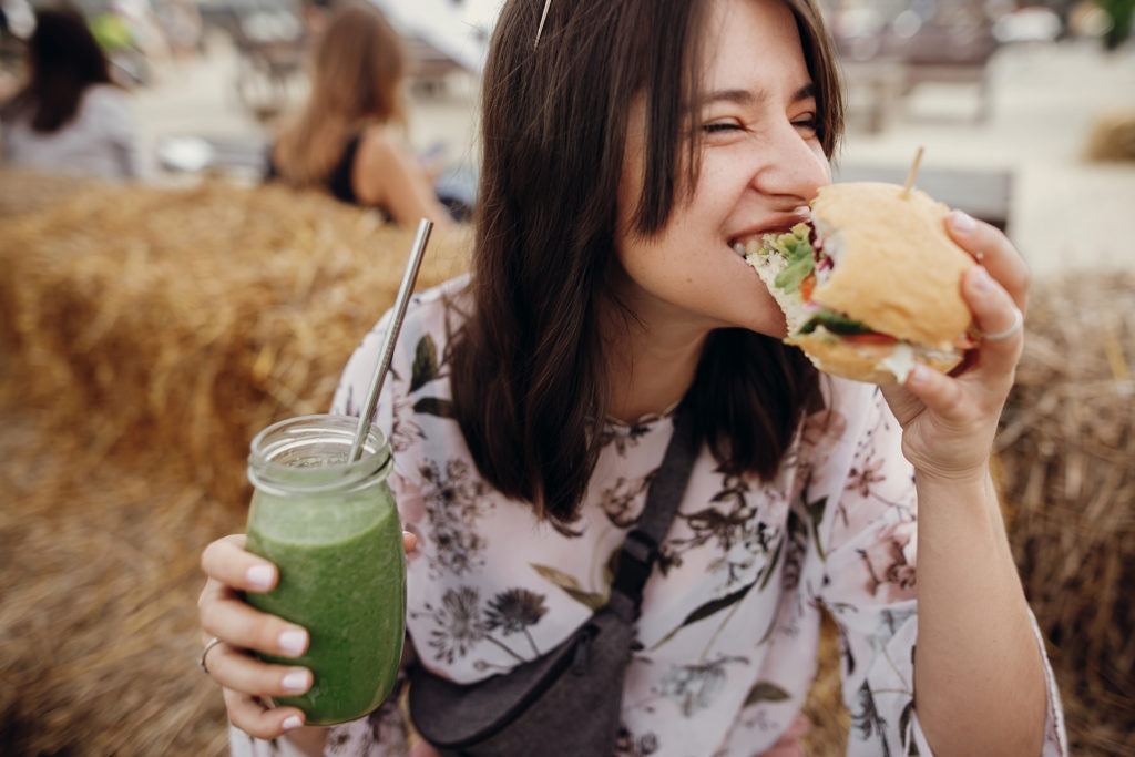 A woman eating food at a festival