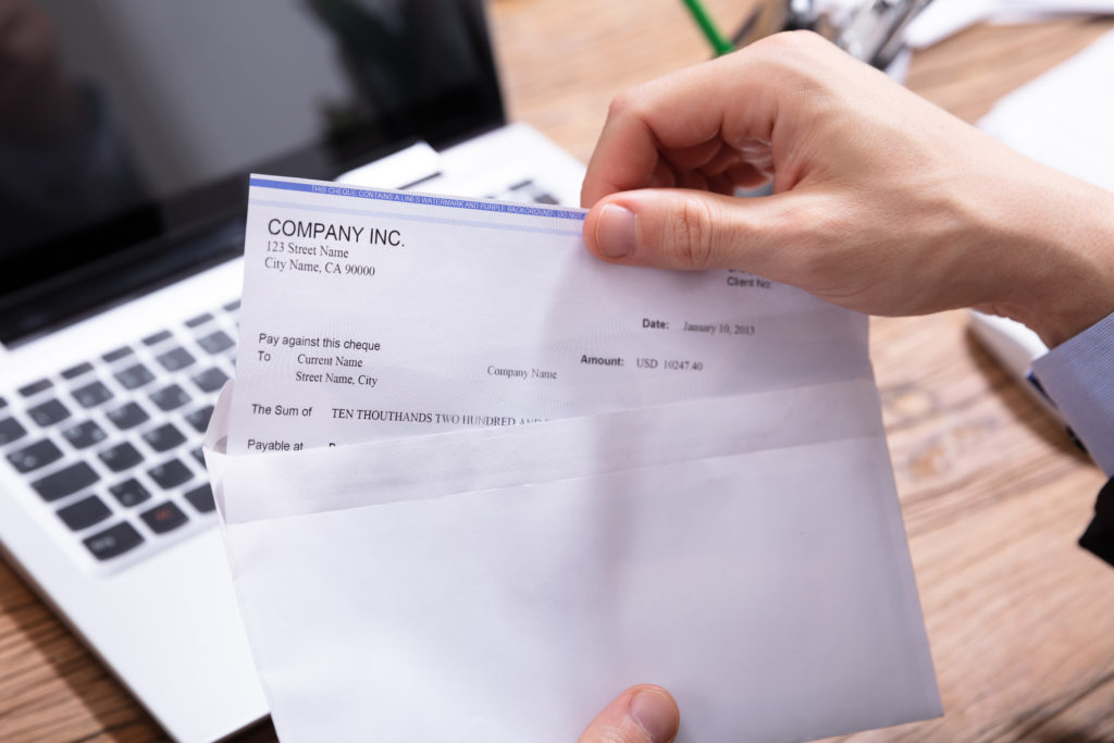 man opening an envelope which he'll then recycle