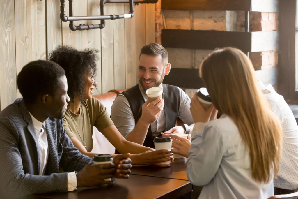people drinking from single-use coffee cups