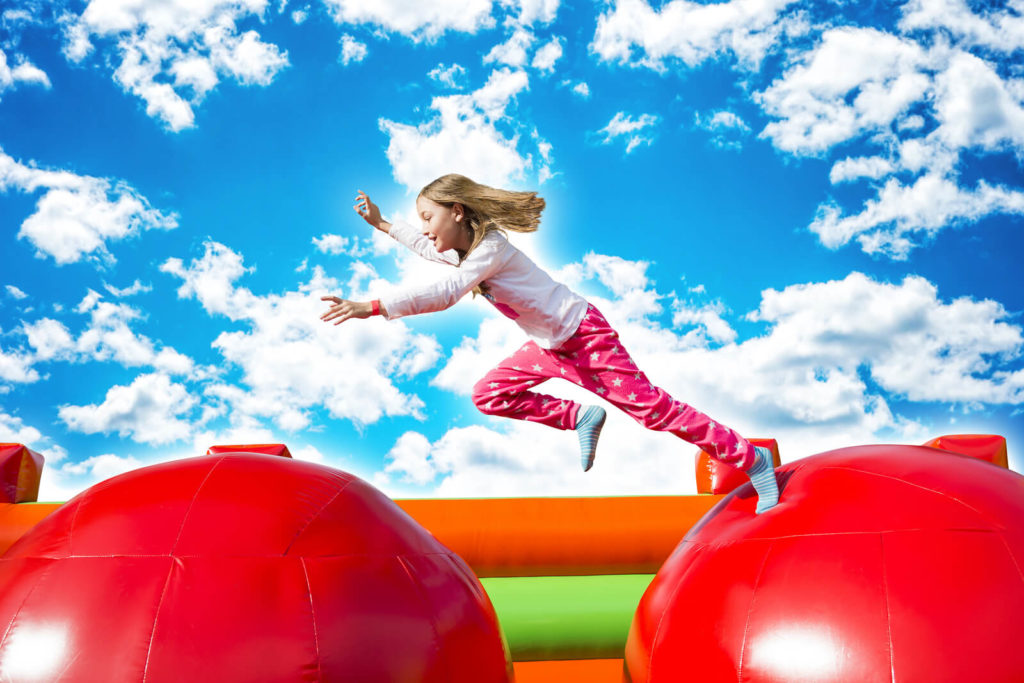child playing on bouncy castle
