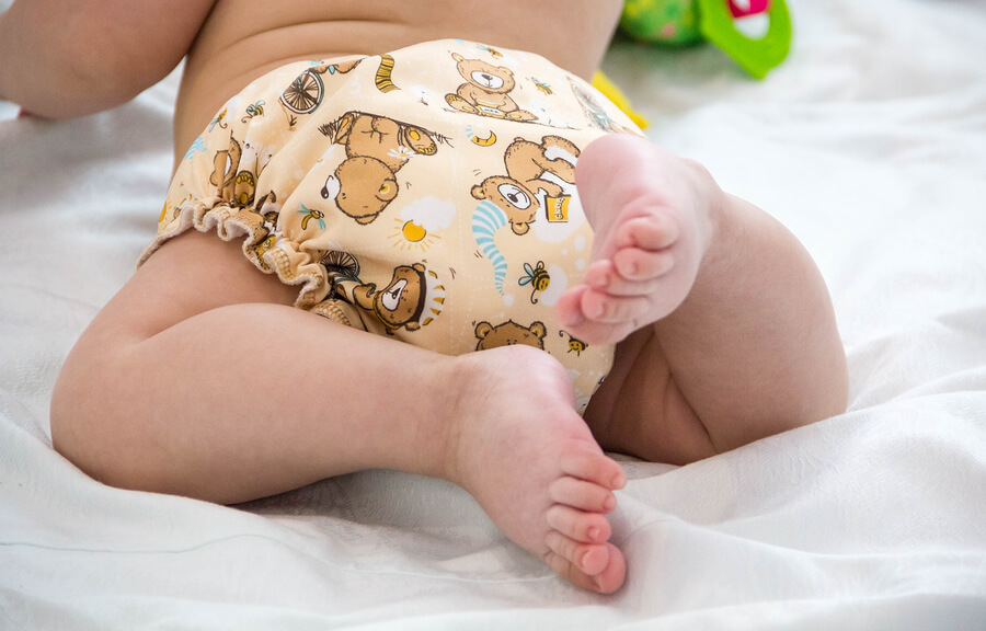 Baby wearing a reusable cloth nappy which is eco-friendly