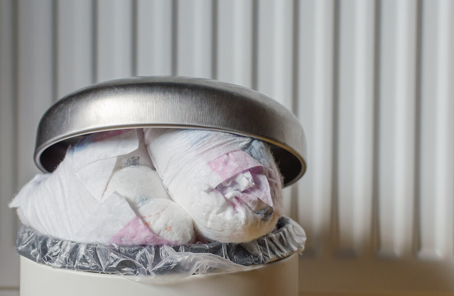 a bin overflowing with disposable nappies
