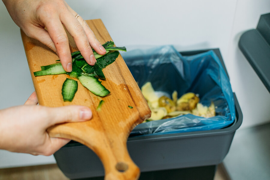 food waste being put in the compost bin