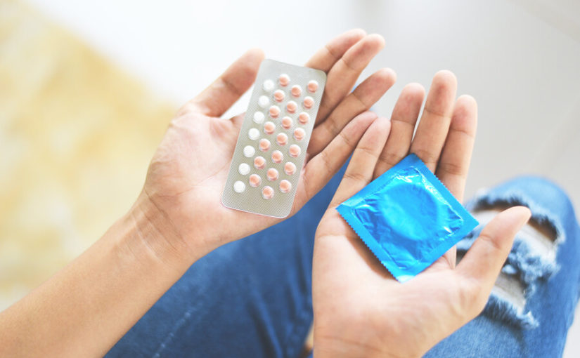 woman holding birth control options