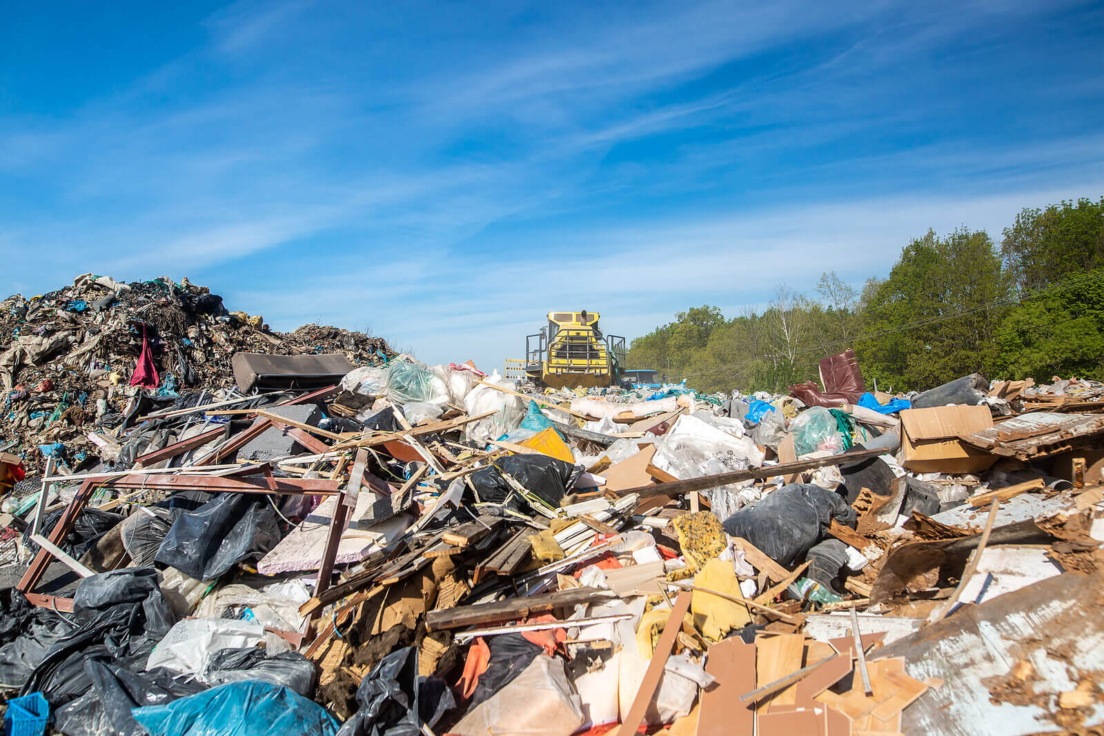 A bulldozer on a landfill site