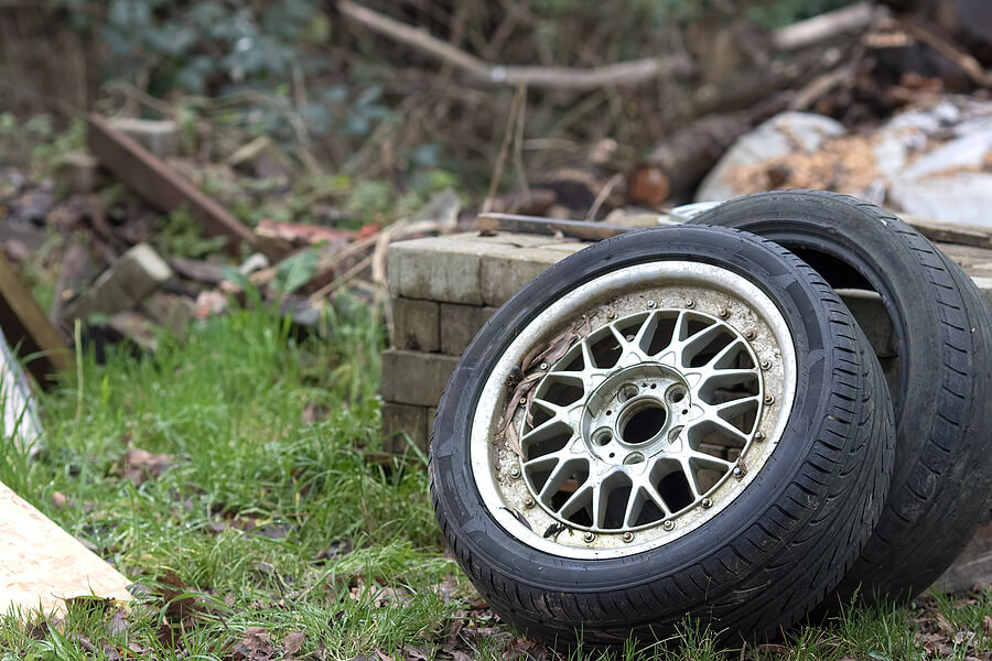 Two fly-tipped car tyres