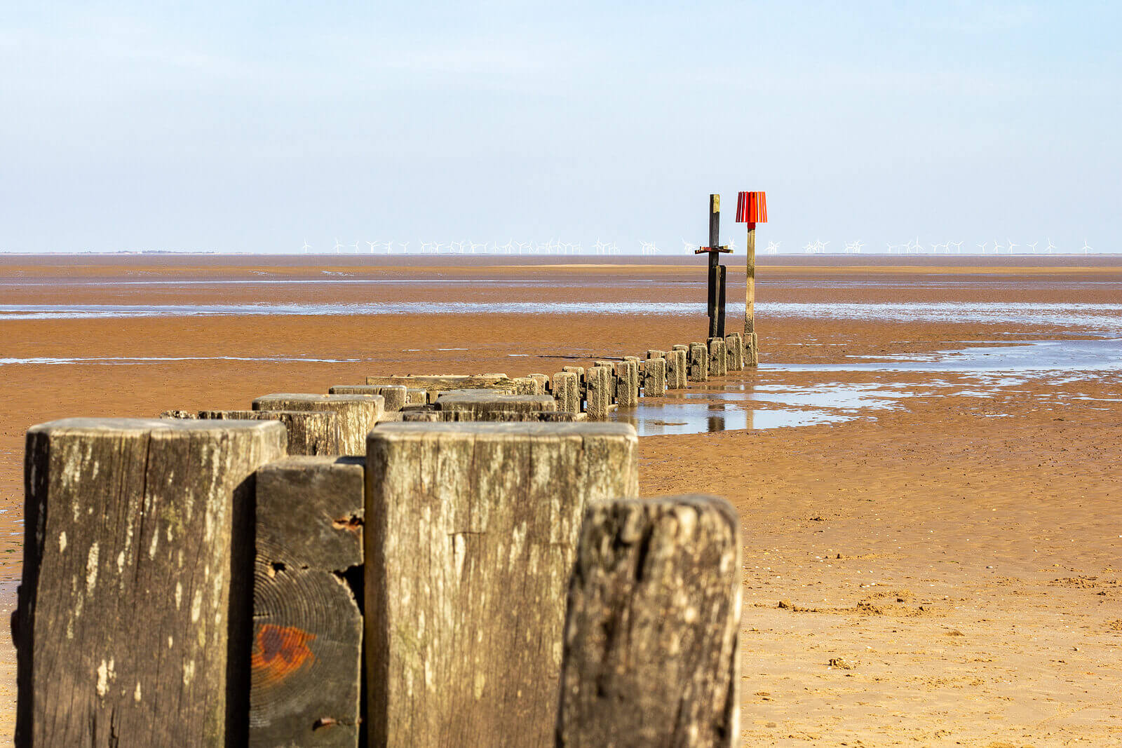 Wooden groynes on Cleethorpes sandy beach