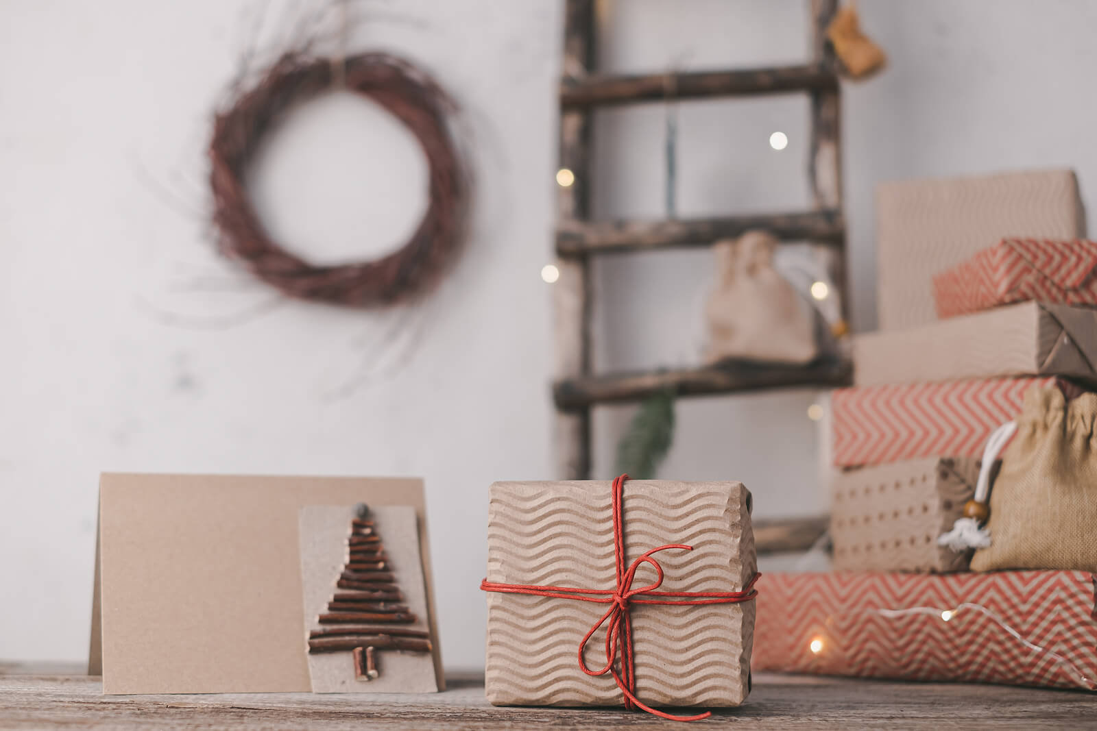A festive scene of wrapped Christmas gifts and a Christmas card, all in recyclable paper.